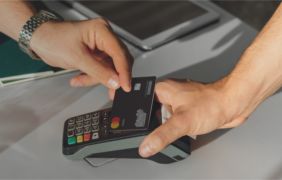 Tapping to ppay with a Brinks Armored Mastercard at a card reader